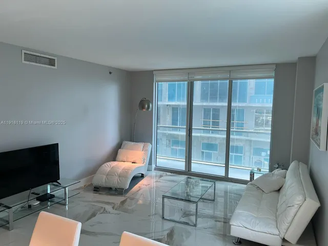 a view of a swimming pool with outdoor seating