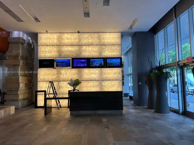 a view of a workspace with furniture and window