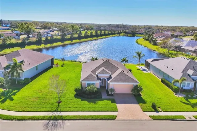 an aerial view of a house with a swimming pool yard and outdoor seating