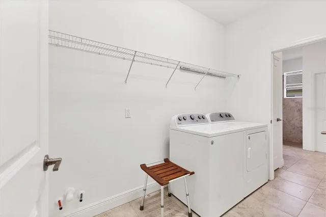 a view of swimming pool with a lounge chairs