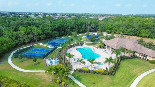an aerial view of a tennis ground and a houses