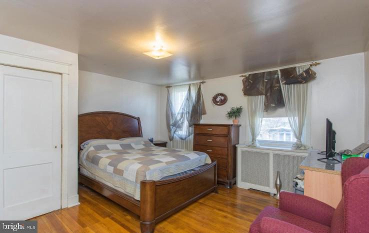 125 Heather Road Upper Darby, PA 19082 - Photo 10 of 15 a bedroom with a bed window and a flat screen tv