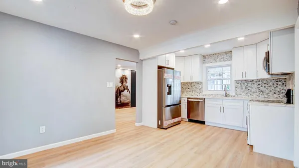 a kitchen with refrigerator and cabinets