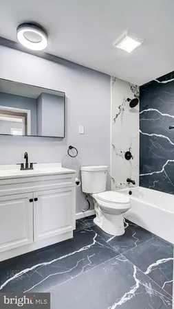 a bathroom with a toilet a sink and a bathtub