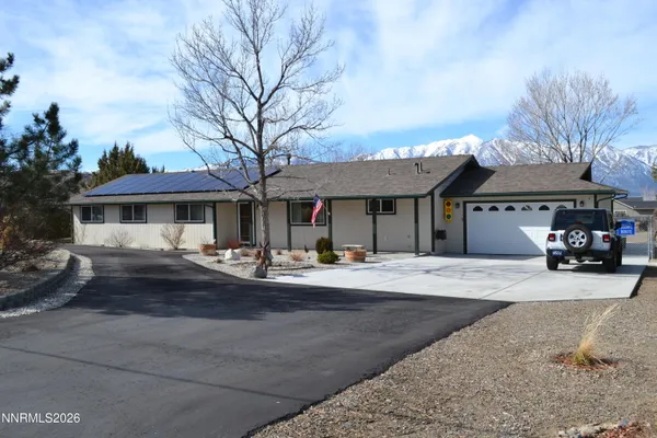 a front view of a house with garage and porch