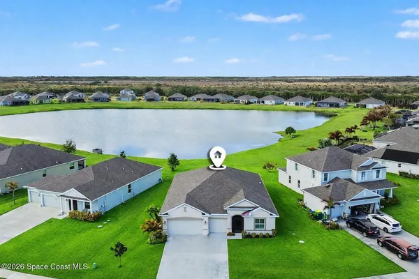 a kitchen with stainless steel appliances a dining table chairs stove refrigerator and cabinets