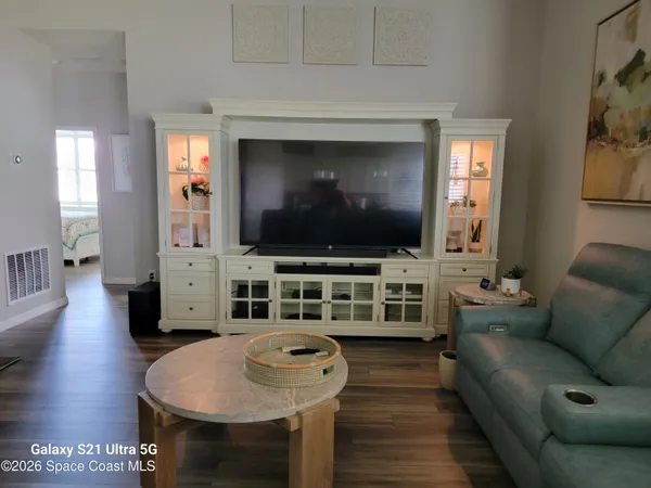 a living room with furniture and a floor to ceiling window