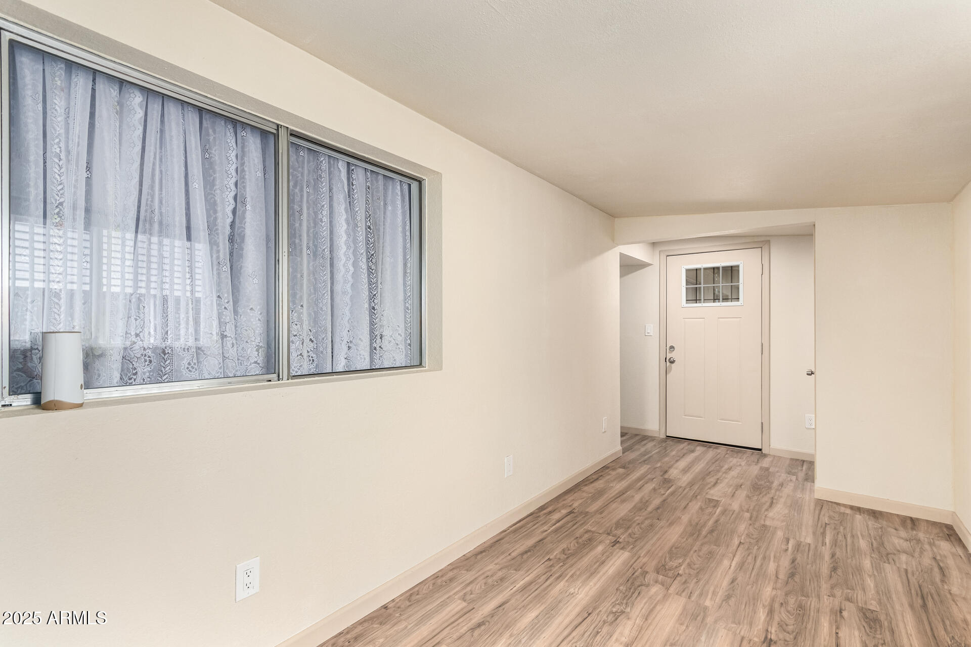 2050 West Dunlap Avenue, Unit R434 Phoenix, AZ 85021 - Photo 20 of 26 a view of an empty room with wooden floor