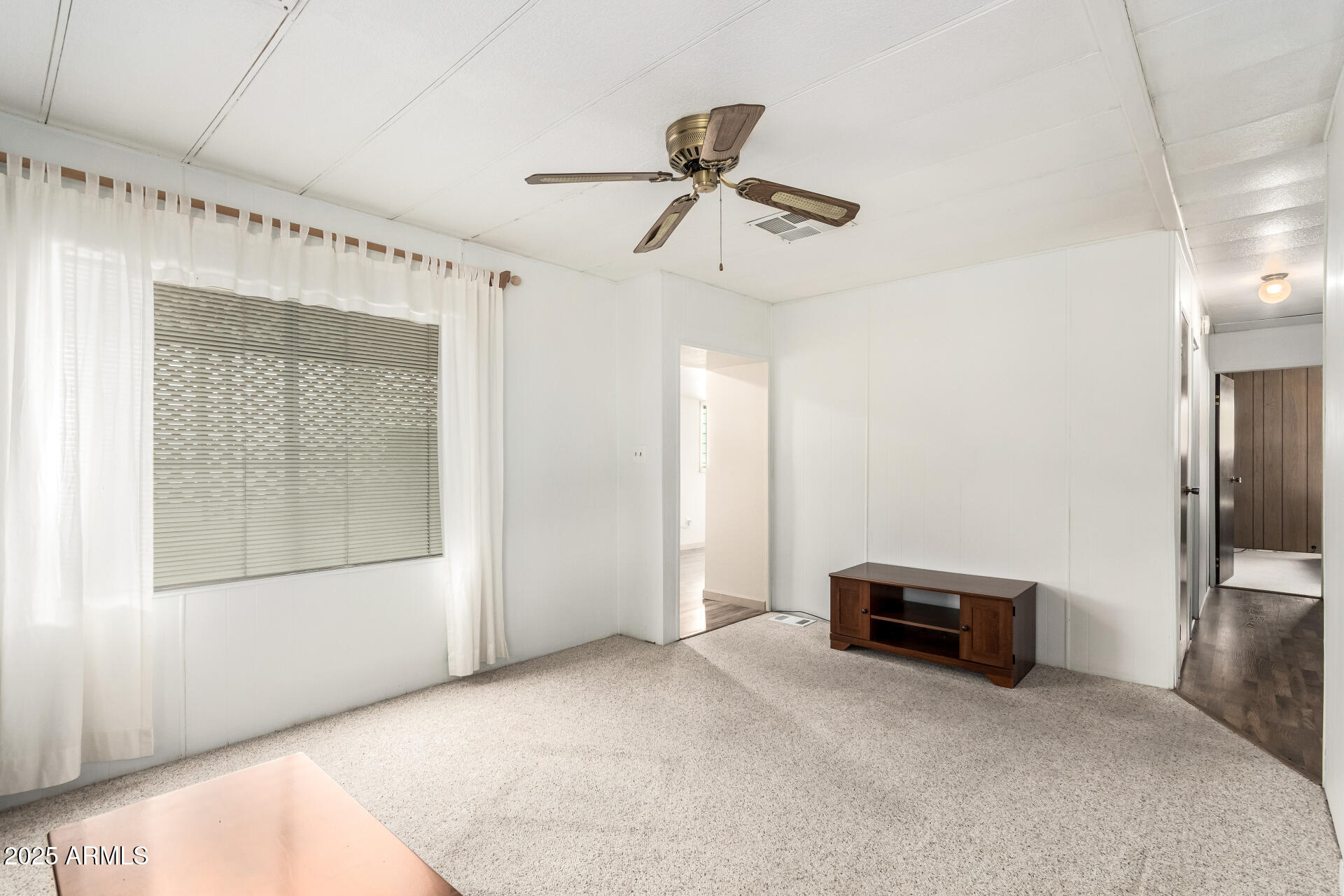 2050 West Dunlap Avenue, Unit R434 Phoenix, AZ 85021 - Photo 6 of 26 a view of empty room with cabinet and wooden floor