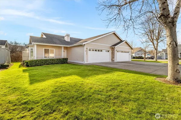a view of a house with a yard and garage