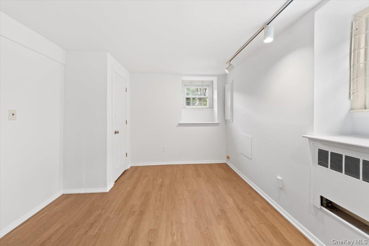 5824 Fieldston Road Bronx, NY 10471 - Photo 26 of 27 a view of a room with wooden floor and white walls