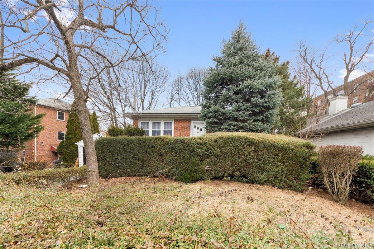 5824 Fieldston Road Bronx, NY 10471 - Photo 3 of 27 a front view of a house with a yard covered with snow in front of house