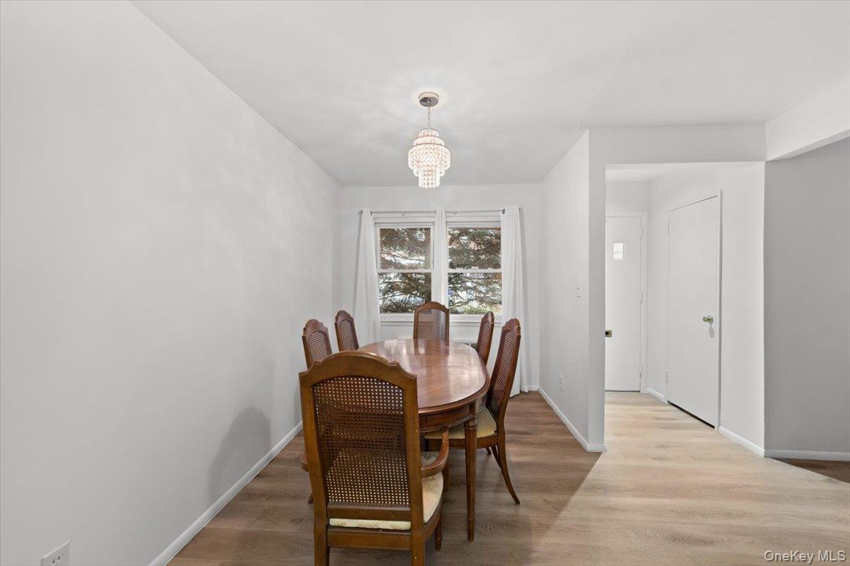 5824 Fieldston Road Bronx, NY 10471 - Photo 8 of 27 a view of a dining room with furniture and wooden floor