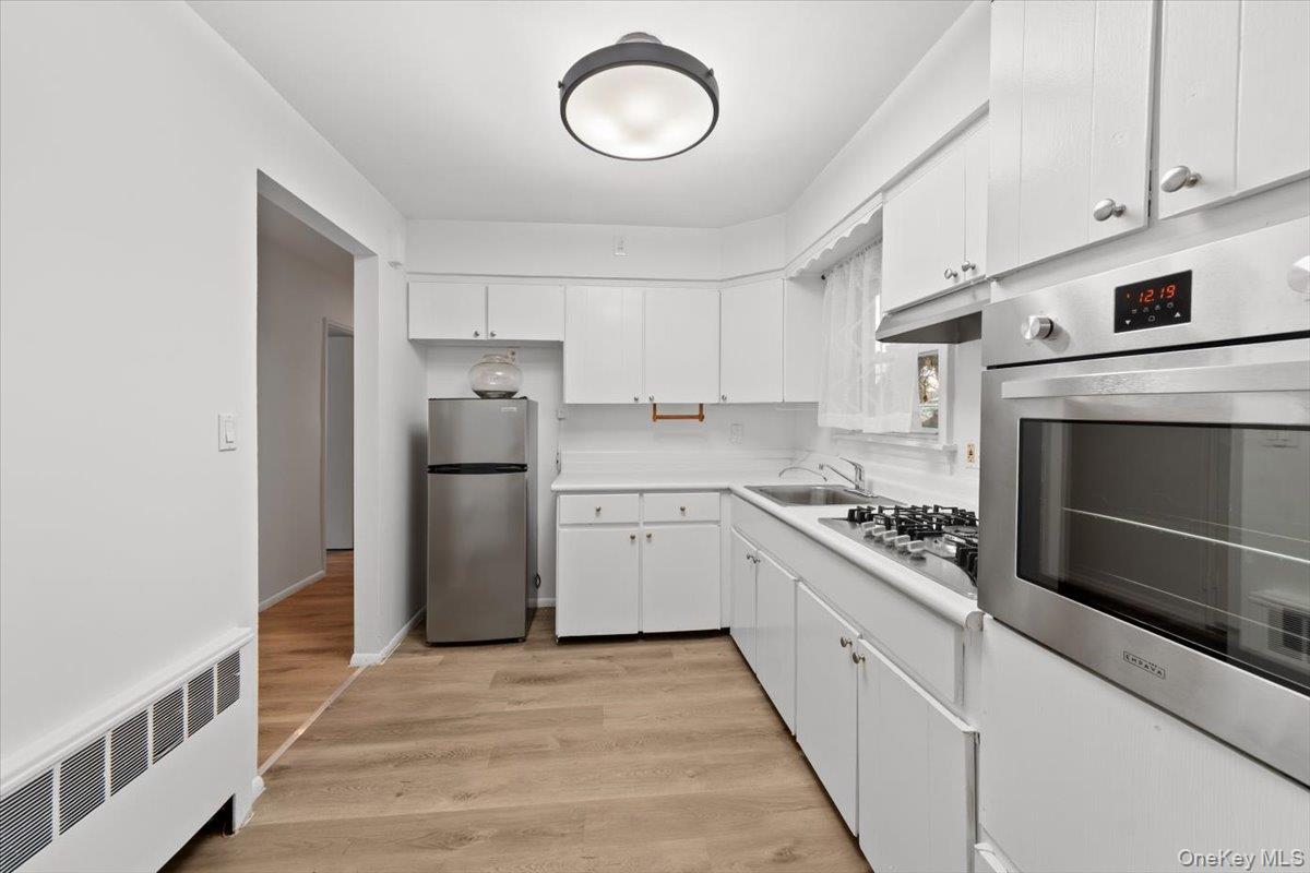 5824 Fieldston Road Bronx, NY 10471 - Photo 9 of 27 a kitchen with stove cabinets and refrigerator