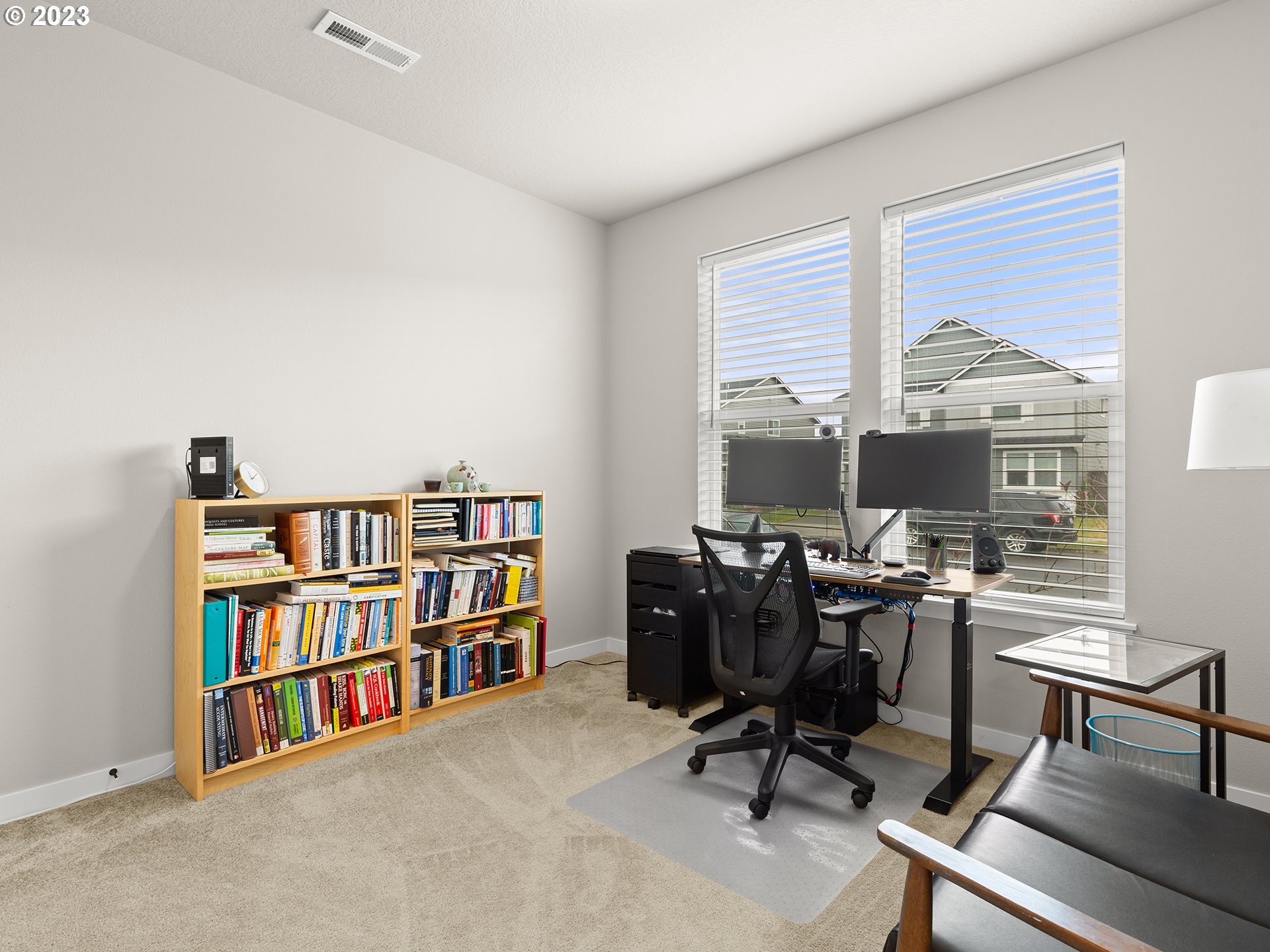 8713 North 1st Street Ridgefield, WA 98642 - Photo 13 of 24 a view of a workspace with furniture and a bookshelf