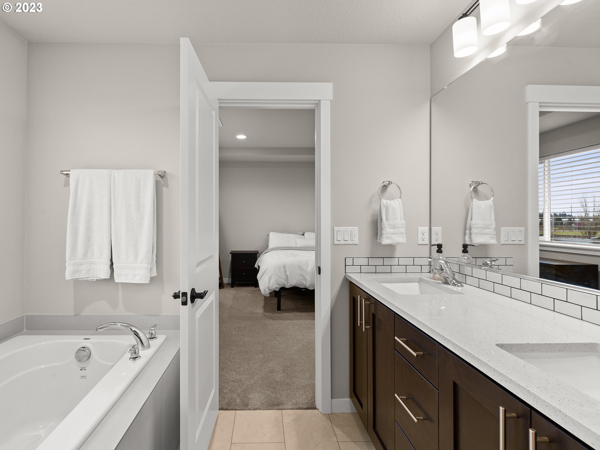8713 North 1st Street Ridgefield, WA 98642 - Photo 16 of 24 a en suite bathroom with a tub double sink and mirror