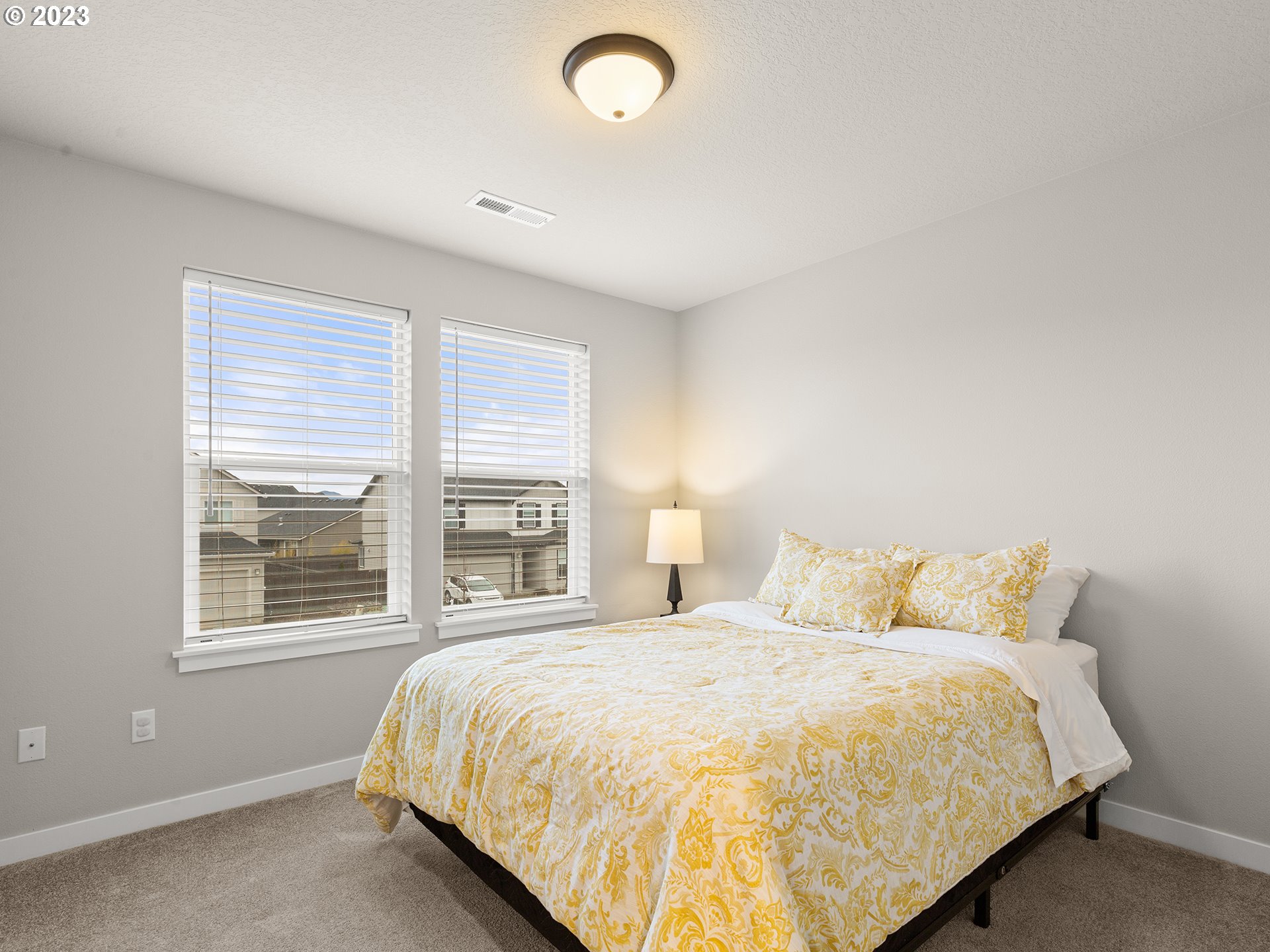 8713 North 1st Street Ridgefield, WA 98642 - Photo 17 of 24 a bedroom with a large bed and a large window