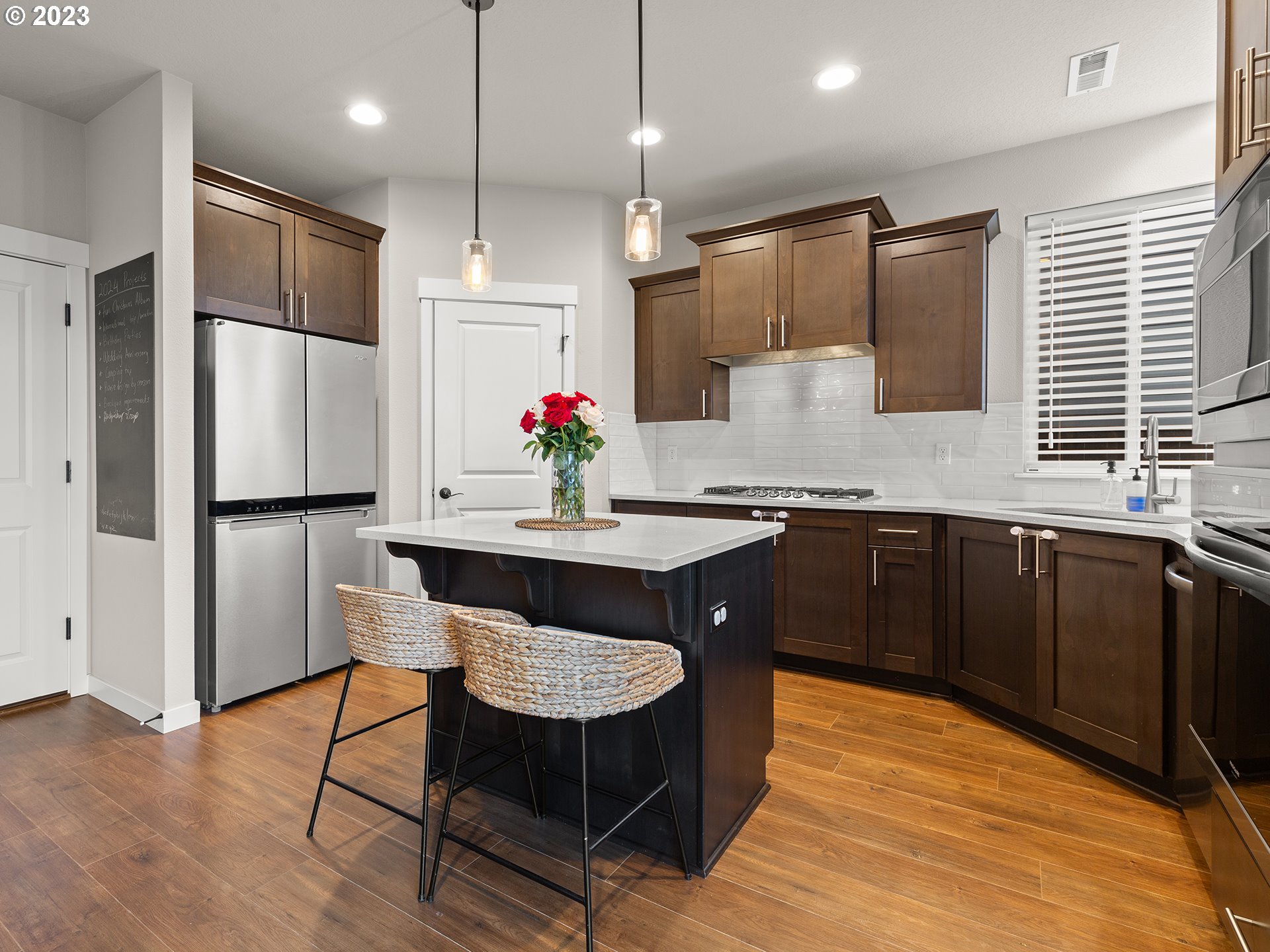 8713 North 1st Street Ridgefield, WA 98642 - Photo 5 of 24 a kitchen with stainless steel appliances granite countertop a sink refrigerator and cabinets