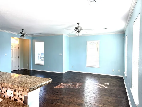 a view of a livingroom with a ceiling fan and window