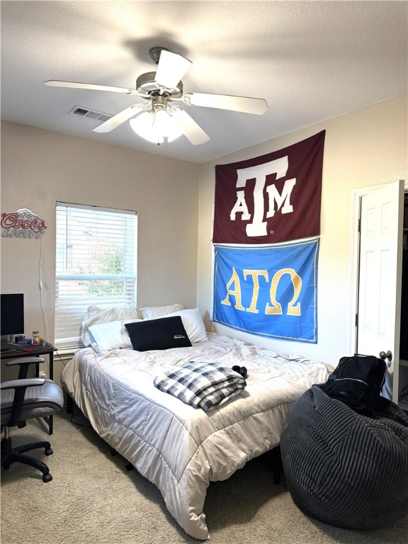 1425 West Villa Maria Road, Unit 306 Bryan, TX 77801 - Photo 14 of 21 a bedroom with a bed and a chandelier