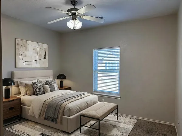 a view of a room with wooden floor and a ceiling fan