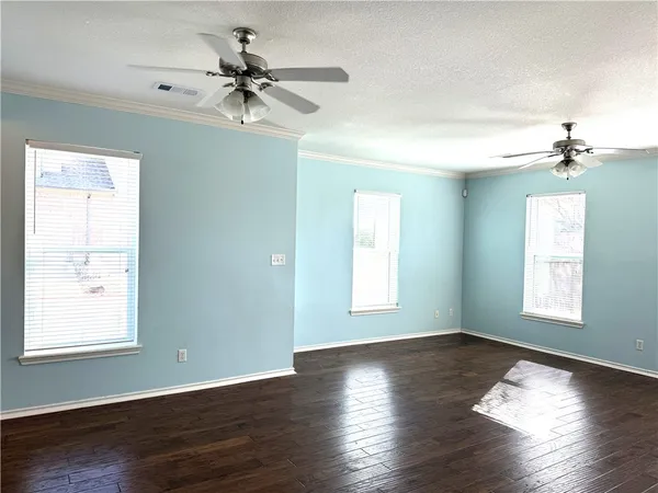 a kitchen with granite countertop a refrigerator stove top oven and sink