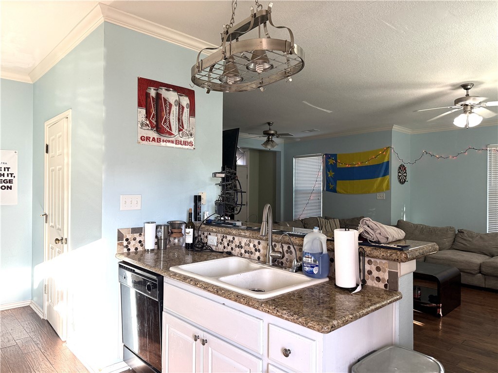 1425 West Villa Maria Road, Unit 306 Bryan, TX 77801 - Photo 21 of 21 a kitchen with a kitchen island a stove and a sink