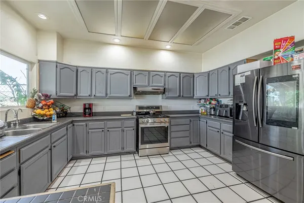a kitchen with stainless steel appliances granite countertop a sink and cabinets