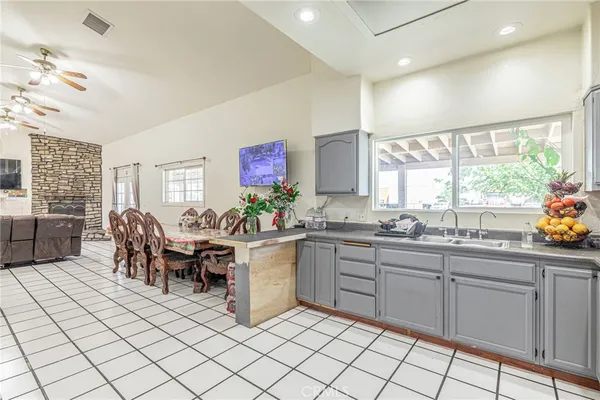 a kitchen with sink cabinets and dining table