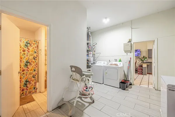 a utility room with multiple dryer and washer
