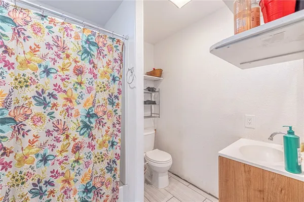 a white toilet sitting next to a shower curtain