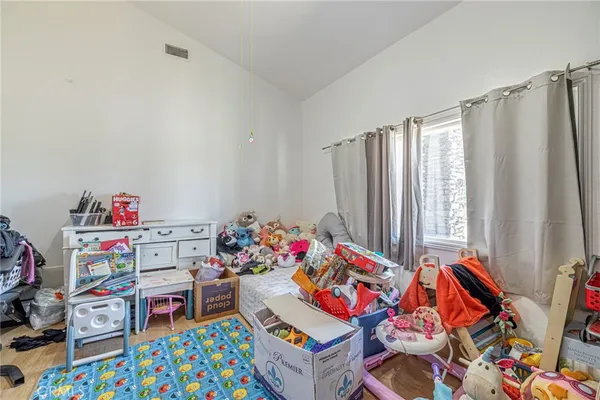 a bedroom with toys and a wooden floor
