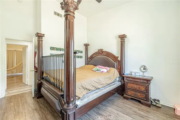 a bedroom with a bed and a book shelf