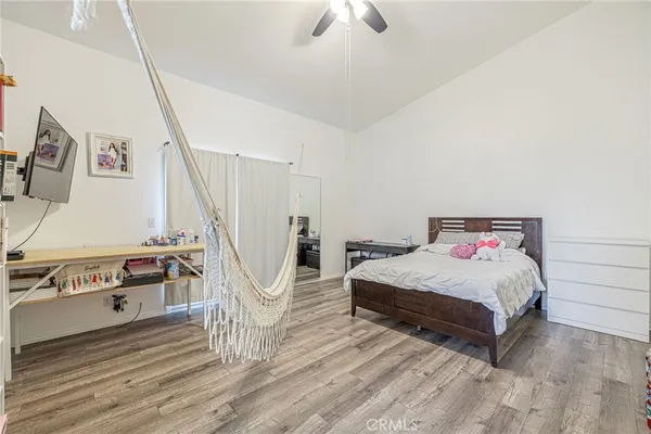 a bedroom with a bed and a chandelier