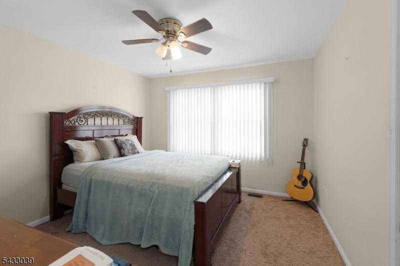 158 Autumn Ridge Road Morris Plains, NJ 07950 - Photo 20 of 26 a bedroom with a bed and a chandelier