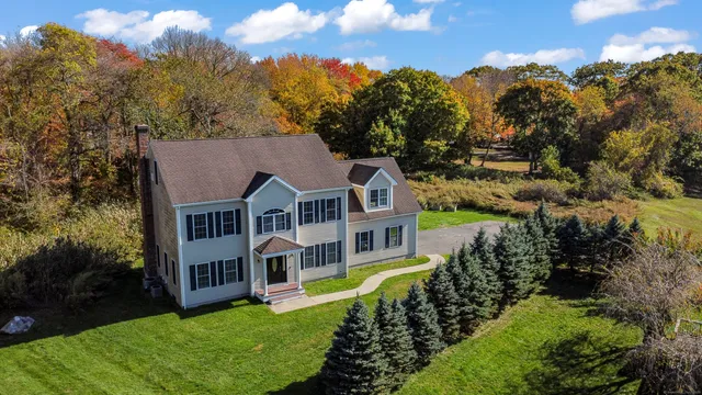 an aerial view of a house with a big yard