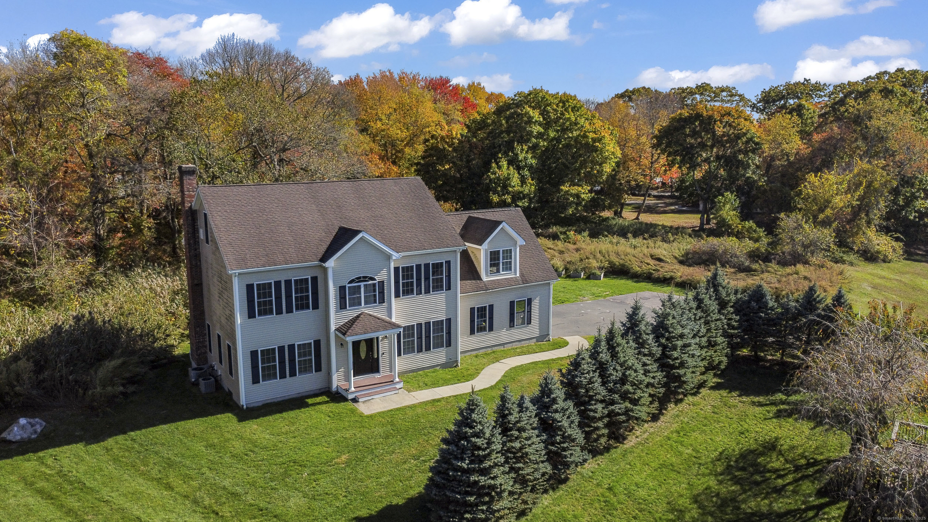an aerial view of a house with a big yard