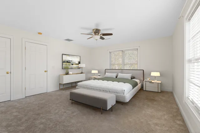 a spacious bedroom with a bed and window