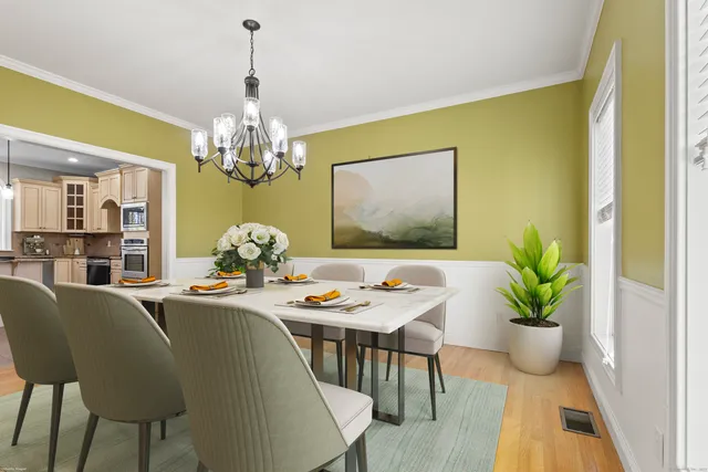 a dining room with furniture and chandelier