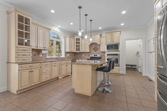 a kitchen with a refrigerator a sink and cabinets