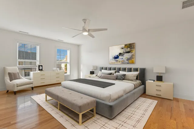 a spacious bedroom with a bed a couch and a window