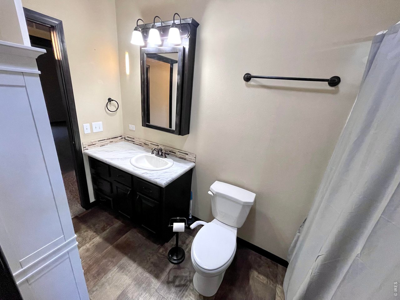 892 Stratton Park Road Bellvue, CO 80512 - Photo 15 of 27 a bathroom with a toilet sink and mirror