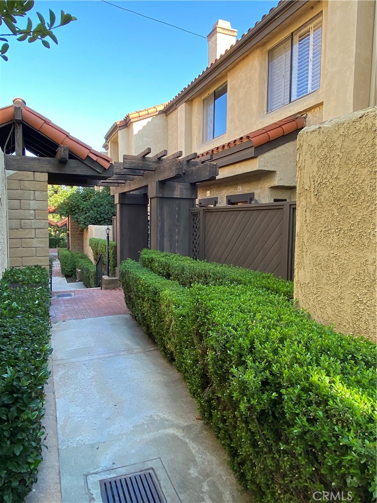 427 East Mission Road, Unit 44 Alhambra, CA 91801 - Photo 1 of 1 a view of a house with brick walls and a yard with plants