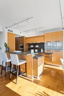 a large kitchen with a large window and cabinets