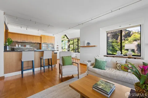 a work room with furniture and large windows
