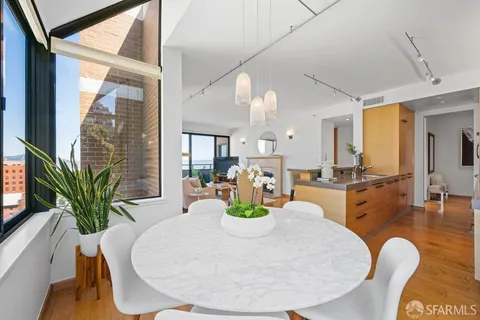 a living room with furniture a flat screen tv and a floor to ceiling window