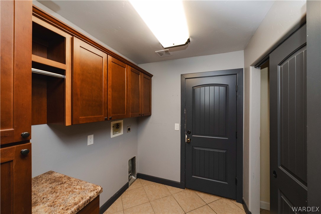 3374 Roma Road Kingman, AZ 86401 - Photo 15 of 64 Laundry room with washer hookup, light tile patterned flooring, and cabinet space