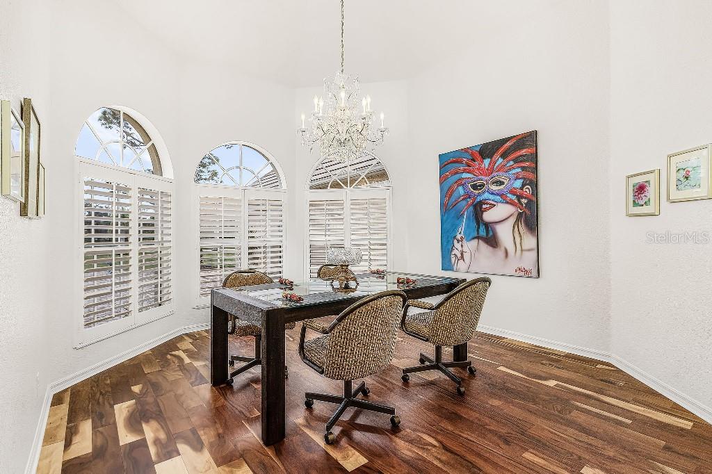 4001 Marianne Key Road Punta Gorda, FL 33955 - Photo 12 of 29 a view of a workspace with furniture and a chandelier