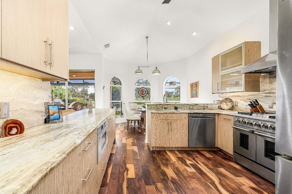 4001 Marianne Key Road Punta Gorda, FL 33955 - Photo 14 of 29 a kitchen with stainless steel appliances granite countertop a sink stove and refrigerator