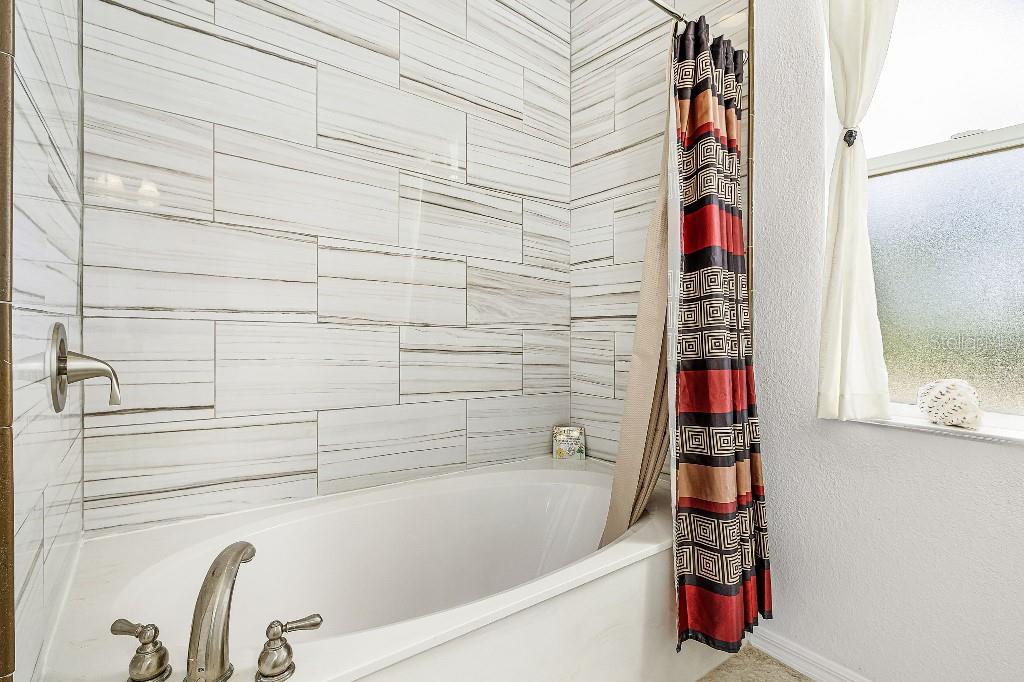 4001 Marianne Key Road Punta Gorda, FL 33955 - Photo 21 of 29 a bathroom with a bathtub and shower